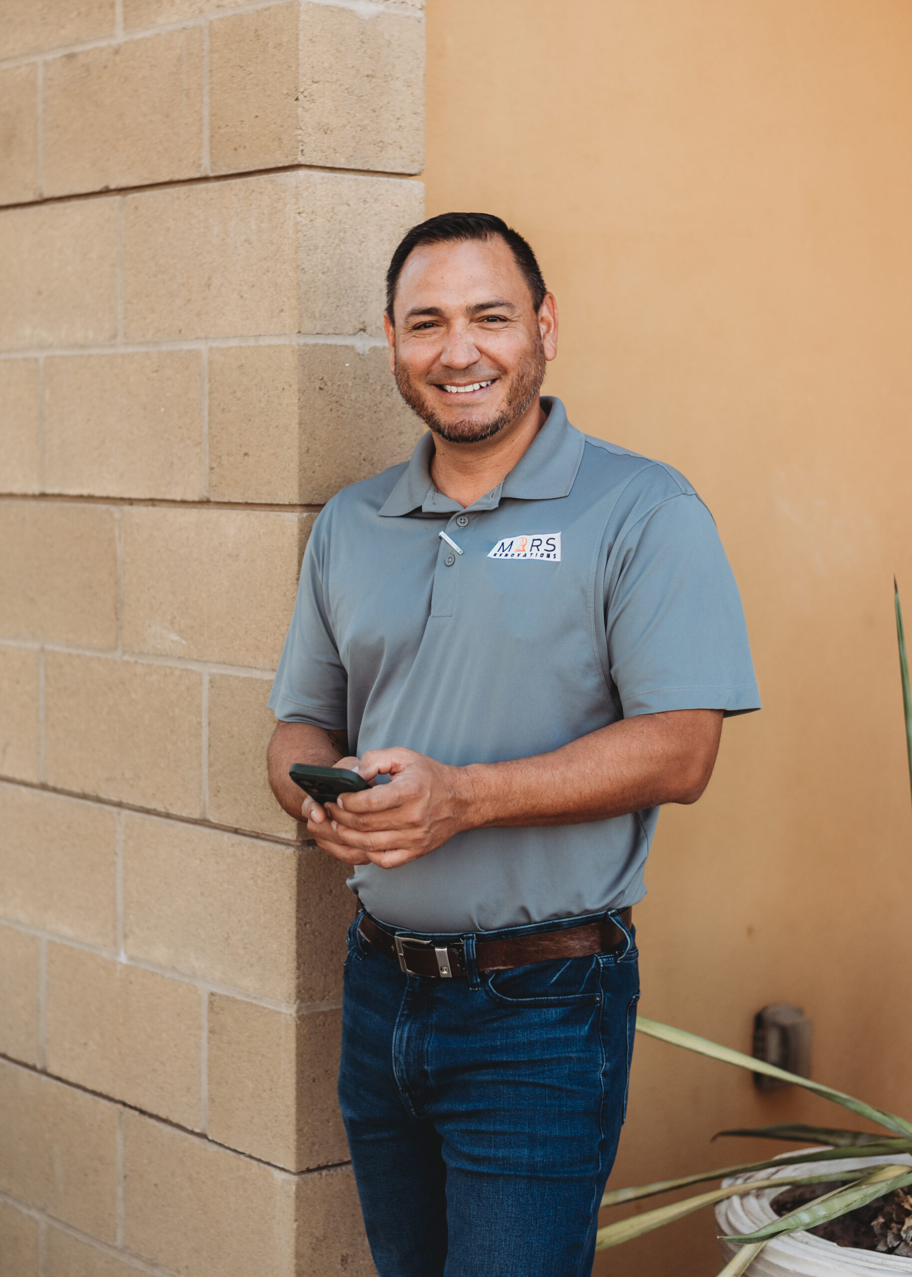 Mars Reno Mahelio standing by wall with phone